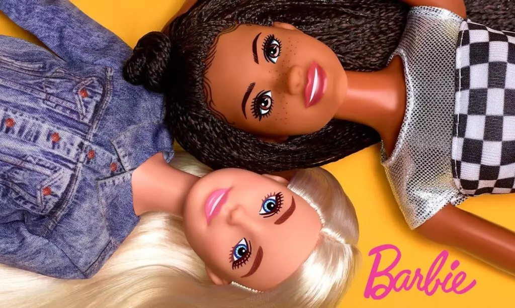 Two Barbie dolls lying down