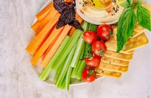 Celery sticks with hummus and sunflower seeds on display