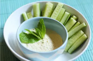 Sliced cucumbers with tzatziki dip in bowl