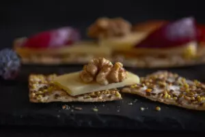 Whole grain crackers with low fat cheese on table